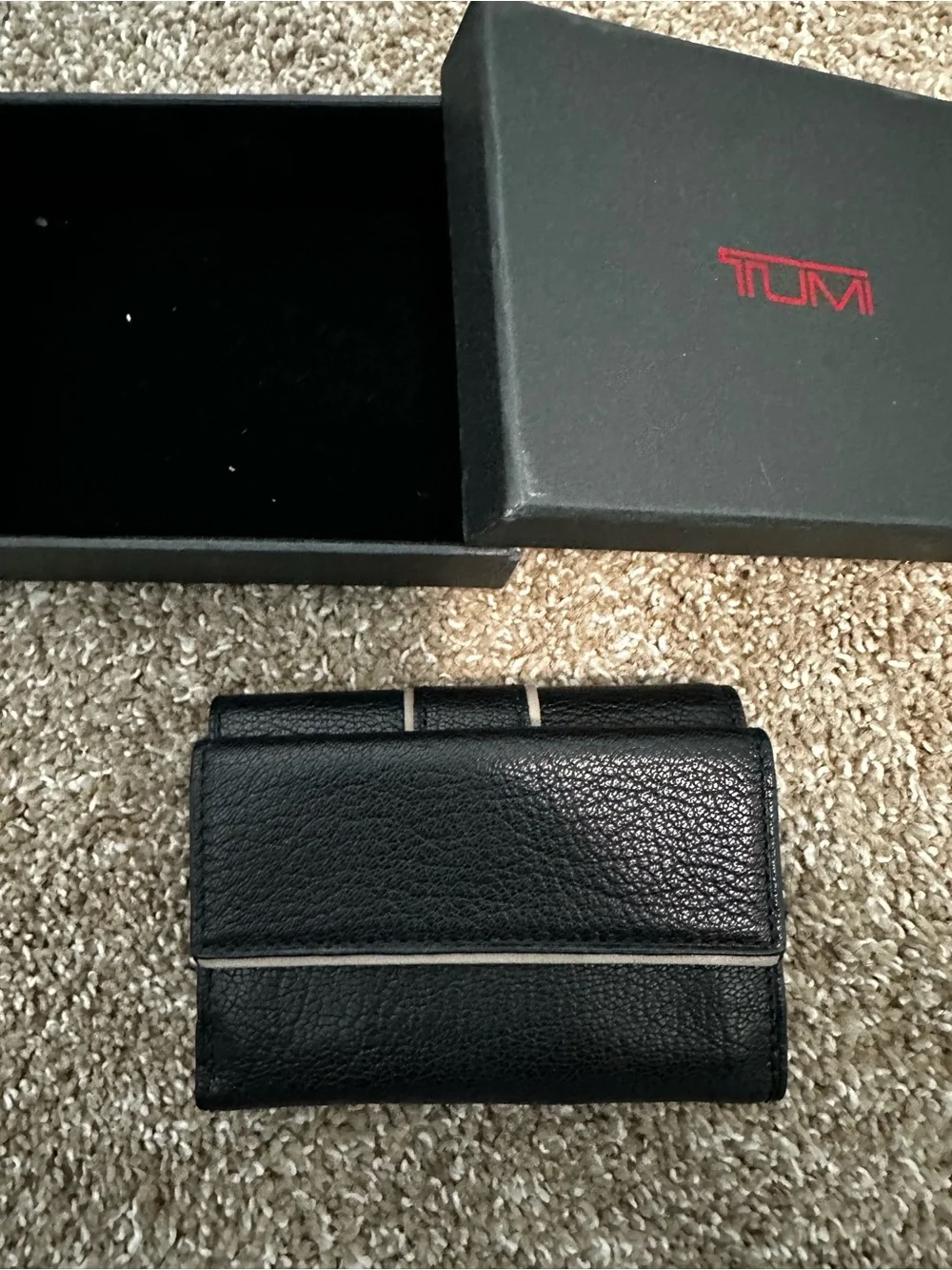 Tumi Black Leather Wallet with Light Trim and Metal Logo